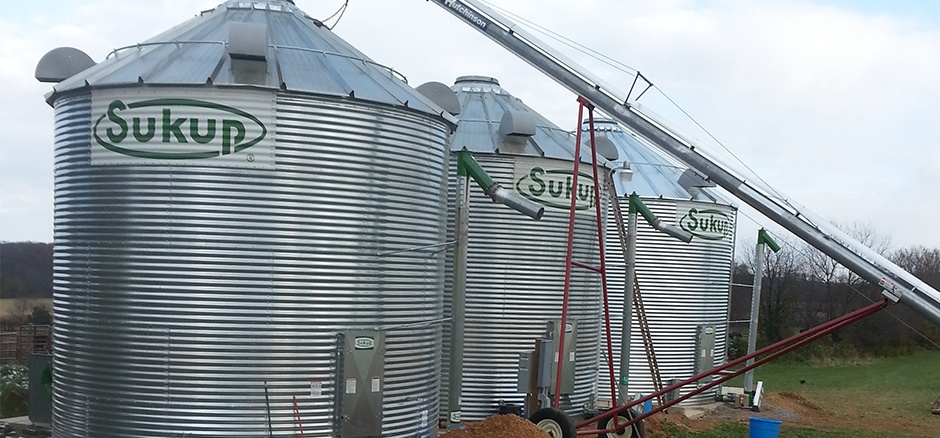 Three metal Sukup silos